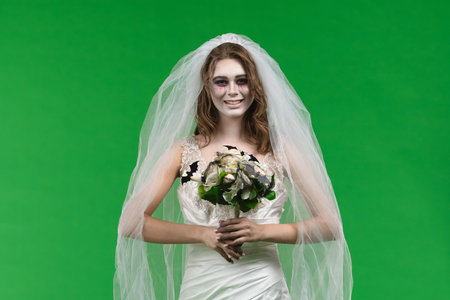 Dead Bride in a Wedding Dress on a Green Backgroundの写真素材