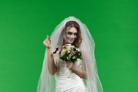 Dead Bride in a Wedding Dress on a Green Backgroundの写真素材