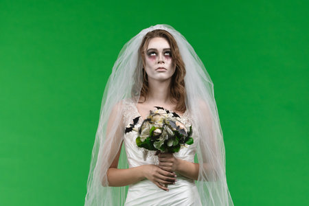 Dead Bride in a Wedding Dress on a Green Backgroundの写真素材