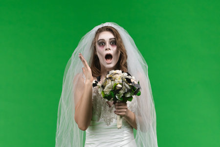 Dead Bride in a Wedding Dress on a Green Backgroundの写真素材