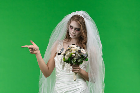 Dead Bride in a Wedding Dress on a Green Backgroundの写真素材