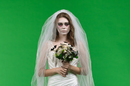 Dead Bride in a Wedding Dress on a Green Backgroundの写真素材