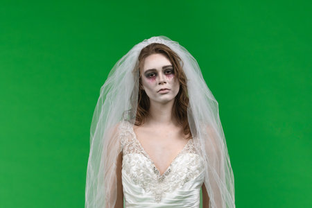 Dead Bride in a Wedding Dress on a Green Backgroundの写真素材