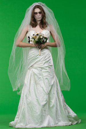 Dead Bride in a Wedding Dress on a Green Backgroundの写真素材