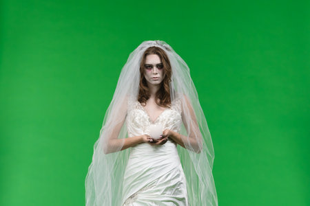 Dead Bride in a Wedding Dress on a Green Backgroundの写真素材