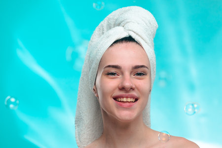 Smiling Woman with Towel on Head and Soap Bubbles