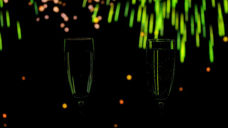 Two glasses of champagne with golden bubbles against a backdrop of warm bokeh fireworks. A festive mood for New Years and Christmas parties.の写真素材