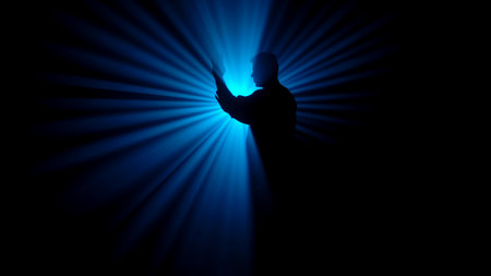 A dark figure of a martial arts master practices his skills, performing various stances in front of a powerful blue light, creating radial rays of illumination.の写真素材