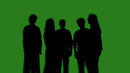 Black silhouettes of a group of people stand together against a green chroma key background. Minimalist contrast and modern visual composition, mockup.の写真素材