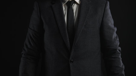 Close up of a person in a formal dark suit and tie, conveying professionalism and elegance.の写真素材