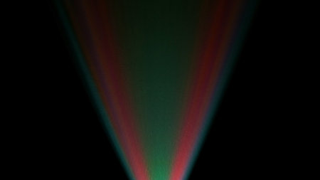Bright colored beams of light from the projector diverge on a dark black background, creating a striking visual effect. Light show on stage, in a theater, or at a disco.の写真素材