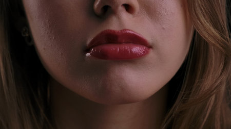 Close up of Woman Lips with Glossy Red Lipstickの写真素材