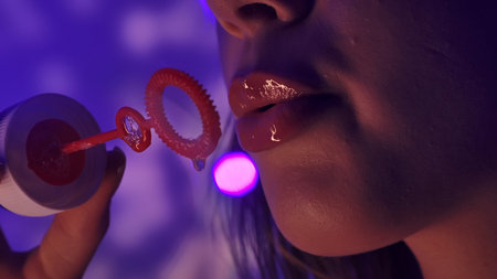 Close up of Woman Blowing Soap Bubbles