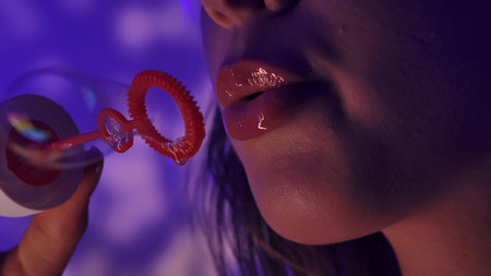 Close up of Woman Blowing Soap Bubbles