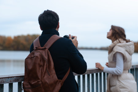 Couple Enjoying Scenic River View in Autumn Dayの写真素材