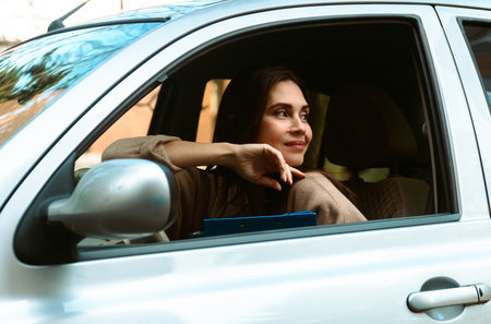 Woman Enjoying Tranquil Moment in Parked Carの写真素材