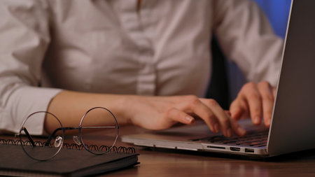 Close Up of Hands Typing on Laptop Keyboardの写真素材