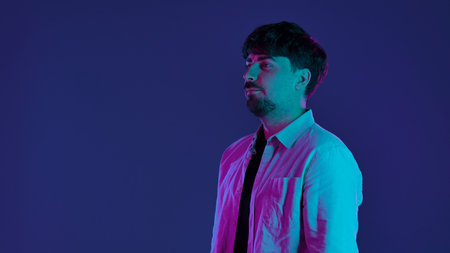 Man in Colorful Neon Lighting on Dark Backgroundの写真素材