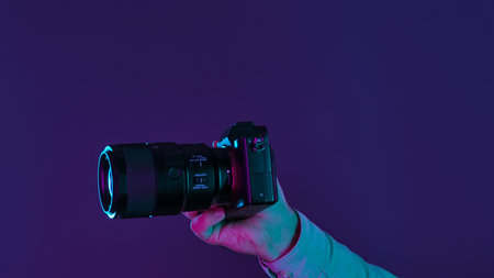Close Up of Camera in Hand with Colorful Lighting