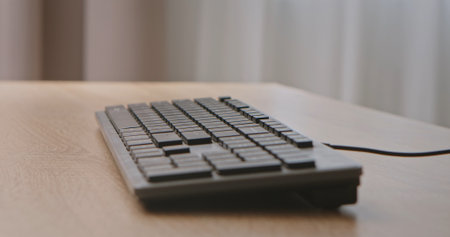 Black Keyboard on Wooden Desk Closeup View
