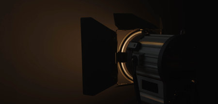 Professional studio spotlight for use in the dark, emitting soft warm light that illuminates part of...