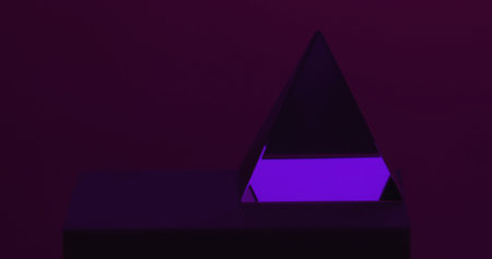 A minimalist abstract photo featuring a purple prism on a dark background, creating a modern artistic aesthetic.の写真素材