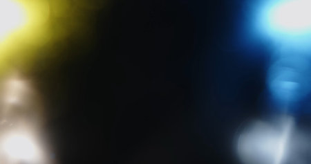 An abstract background featuring a blue and orange bokeh pattern. The soft, out of focus lights...
