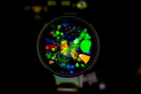 Colorful bokeh lights reflected in a camera lens, creating a vibrant and artistic visual effect.
