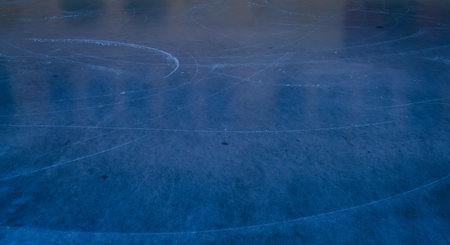 Abstract top view of scratched blue ice rink surface with skate marks and frozen texture. Cold winter background for sports, skating, seasonal and design concepts.の写真素材