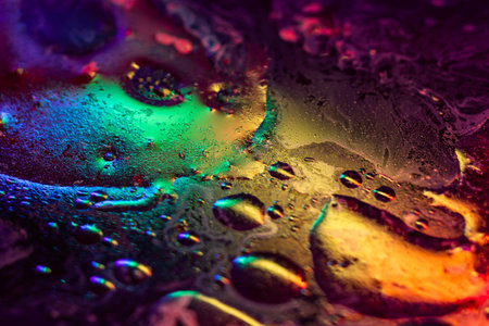 Colorful abstract divorces of oily liquid with neon red, blue and green highlights. Bubbles, stains...
