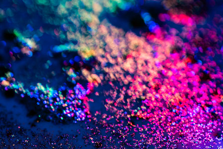 Blurred, defocused background bokeh colorful abstract divorces of oily liquid with neon red, blue...