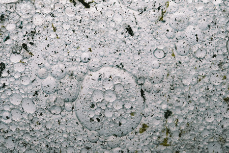 Abstract background of paint divorces, streaks and particles suspended in liquid with many small...