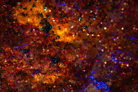 Abstract background of colored glitter on divorces liquid surface. Concepts for beauty, holidays and...
