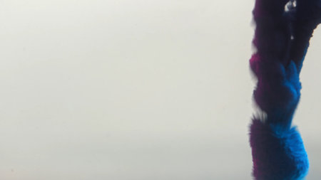 Blue paint cloud spreading in water on a white background. Premium marketing concept for overlay effects, creative branding, banner and advertising layout design, ecology, beauty, and fashion.の写真素材