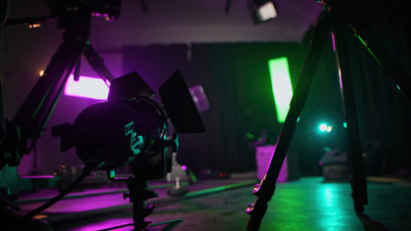 Background with camera slider with colorful lights, smoke, and backstage equipment. Concept of video...