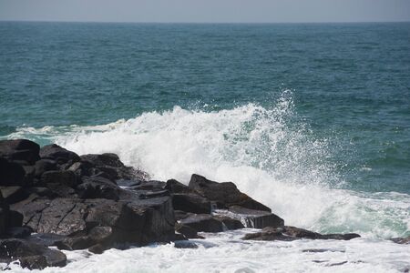 Waves breaking on a rock