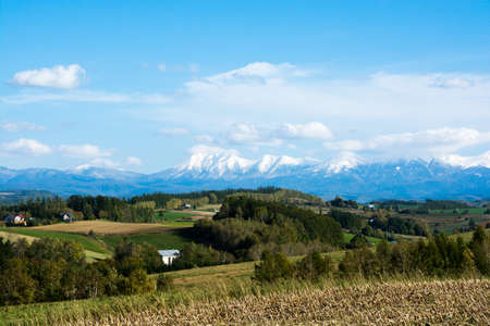 Autumn fields and snow-capped mountains