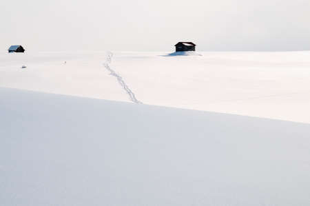 Snow hills and human footprintsの写真素材