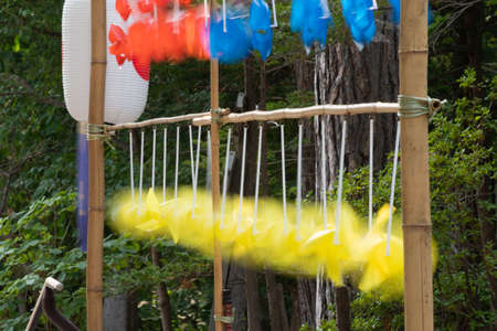 Yellow toy windmill spinning in the windの写真素材