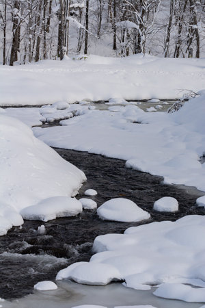 Stream where the snow has begun to meltの写真素材