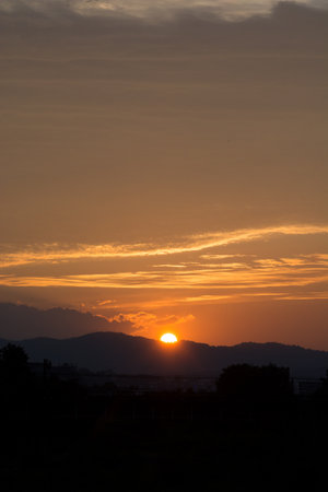 Sunset over the edge of the mountainの写真素材