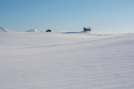 Snowfields and mountains on a sunny winter dayの写真素材