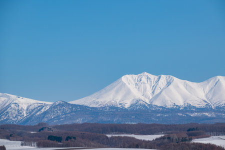 Snowy mountains and blue sky in Hokkaido, Japan.の写真素材