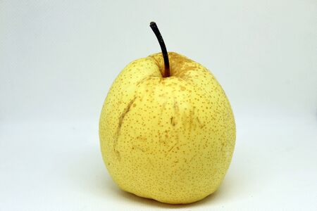 Yellow pear, rough skin, unattractive, made for sale at a cheap price on a white backgroundの写真素材