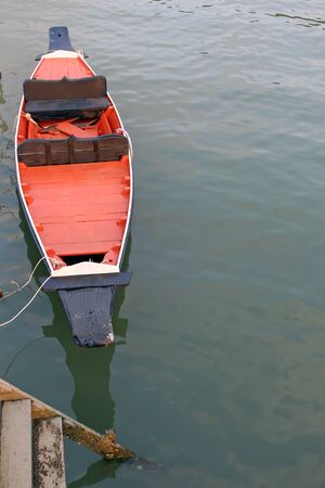 Rowing boats tied to stairs along the waterfront waiting for tourists to row.の写真素材