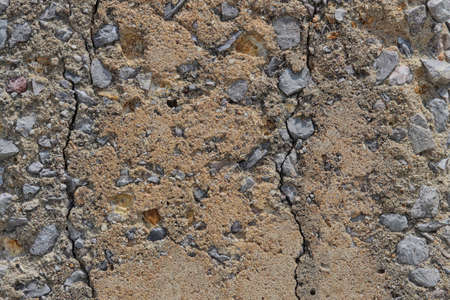 The background image is caused by the cracking of a cement pillar made of limestone and sand.の写真素材