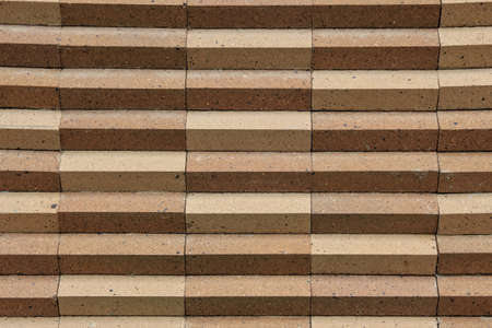 The background image of triangles comes from brickwork covered over large cement columns.の写真素材
