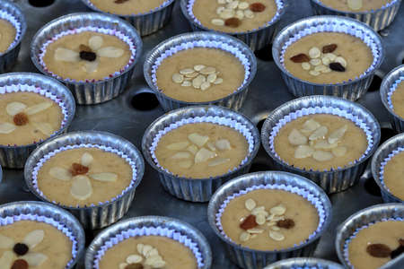 Banana cakes are packed in paper cups placed in a large aluminum steamer. Ready to steam it into a...