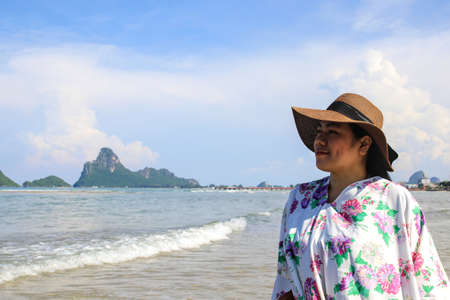 The girl smiled relaxedly while enjoying nature on the beach. On a short vacationの写真素材