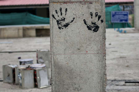 The left and right handprints of the craftsmen were stamped on the concrete pillars simply because they wanted to wipe their soiled hands.の写真素材